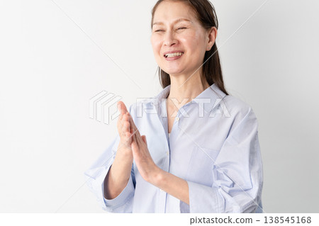A senior woman in casual clothes standing – a lifestyle image. A senior woman in casual clothes standing – a lifestyle image. 138545168
