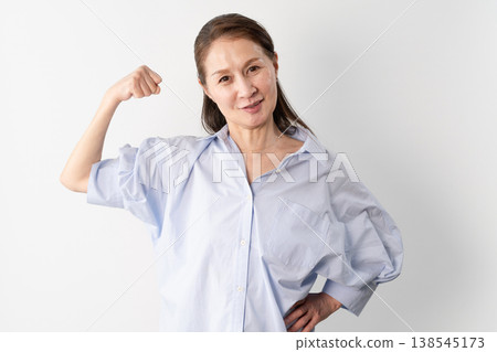 A senior woman in casual clothes standing – a lifestyle image. A senior woman in casual clothes standing – a lifestyle image. 138545173