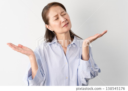A senior woman in casual clothes standing – a lifestyle image. A senior woman in casual clothes standing – a lifestyle image. 138545176