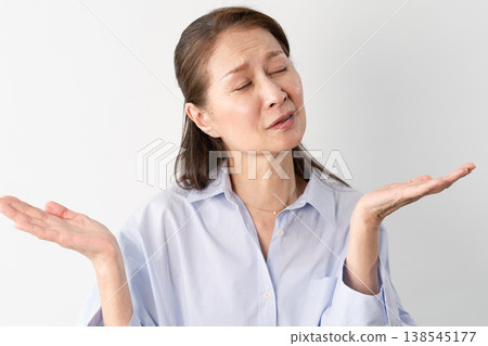 A senior woman in casual clothes standing – a lifestyle image. A senior woman in casual clothes standing – a lifestyle image. 138545177