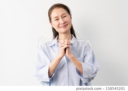 A senior woman in casual clothes standing – a lifestyle image. A senior woman in casual clothes standing – a lifestyle image. 138545201