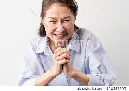 A senior woman in casual clothes standing – a lifestyle image. A senior woman in casual clothes standing – a lifestyle image. 138545205