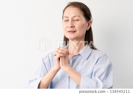 A senior woman in casual clothes standing – a lifestyle image. A senior woman in casual clothes standing – a lifestyle image. 138545211