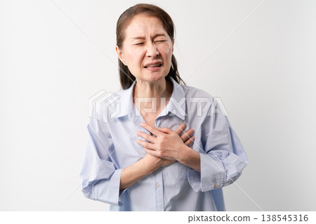 A senior woman in casual clothes standing – a lifestyle image. A senior woman in casual clothes standing – a lifestyle image. 138545316