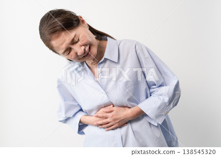 A senior woman in casual clothes standing – a lifestyle image. A senior woman in casual clothes standing – a lifestyle image. 138545320
