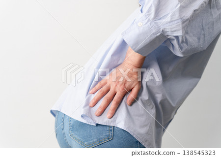 A senior woman in casual clothes standing – a lifestyle image. A senior woman in casual clothes standing – a lifestyle image. 138545323