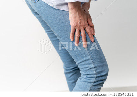 A senior woman in casual clothes standing – a lifestyle image. A senior woman in casual clothes standing – a lifestyle image. 138545331