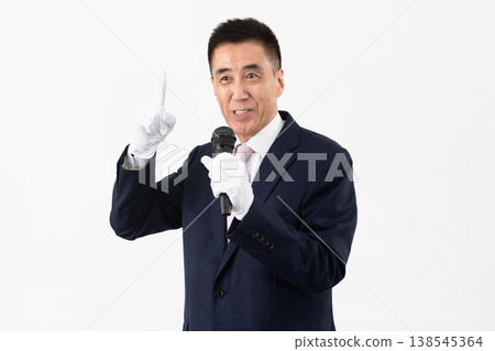 Senior man giving a campaign speech while holding a microphone Senior man giving a campaign speech while holding a microphone 138545364