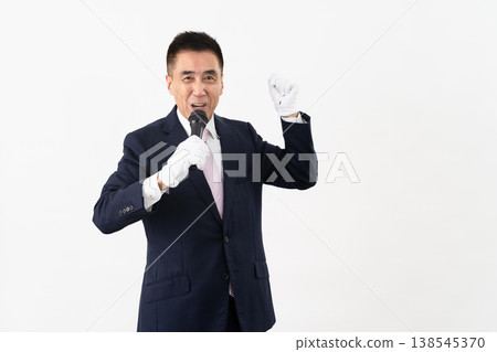Senior man giving a campaign speech while holding a microphone Senior man giving a campaign speech while holding a microphone 138545370