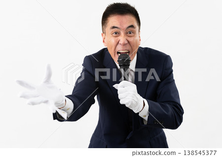 Senior man giving a campaign speech while holding a microphone Senior man giving a campaign speech while holding a microphone 138545377