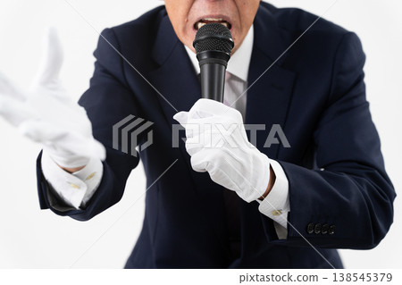 Senior man giving a campaign speech while holding a microphone Senior man giving a campaign speech while holding a microphone 138545379