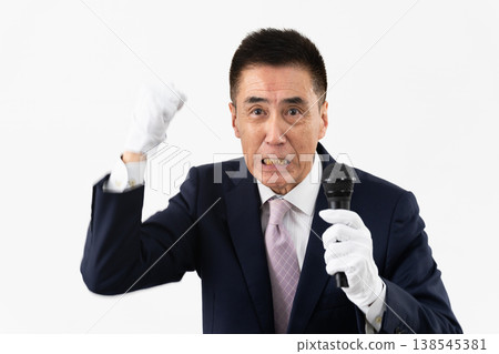 Senior man giving a campaign speech while holding a microphone 138545381