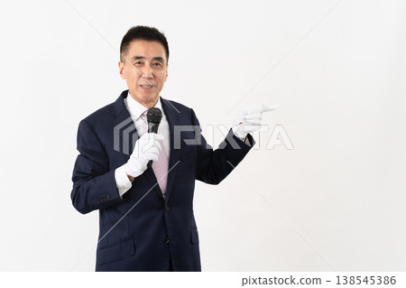 Senior man giving a campaign speech while holding a microphone Senior man giving a campaign speech while holding a microphone 138545386
