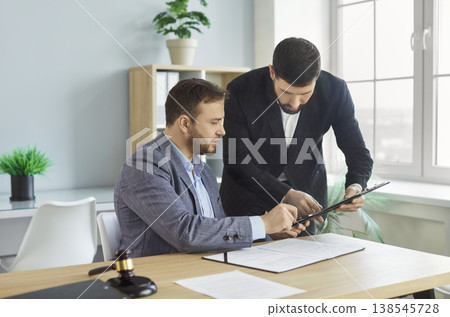 Male lawyer having a meeting with a client and discussing contract in the office. 138545728
