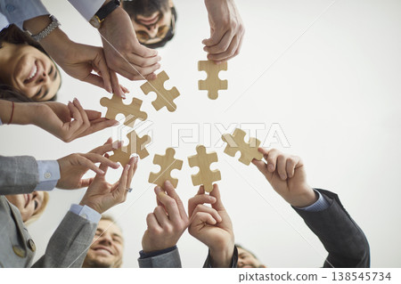 Jigsaw puzzles match, diverse colleagues holding wooden pieces, finding idea, searching business Jigsaw puzzles match, diverse colleagues holding wooden pieces, finding idea, searching business 138545734