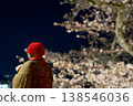 Cherry blossoms at night and a melancholic Jizo statue 138546036