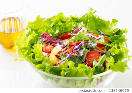 Vegetable salad and olive oil on the table Vegetable salad and olive oil on the table 138546079