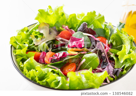 Vegetable salad and olive oil on the table 138546082