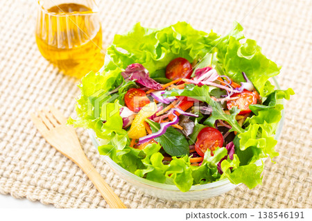 Vegetable salad and olive oil on the table Vegetable salad and olive oil on the table 138546191