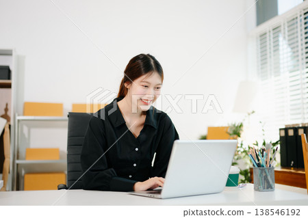 Young business owner woman prepare parcel box and standing check online orders for deliver to customer on tablet, laptop Shopping Online concept. Young business owner woman prepare parcel box and standing check online orders for deliver to customer on tablet, laptop Shopping Online concept. 138546192