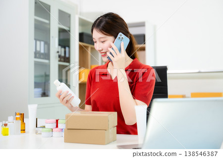 Young business owner woman prepare parcel box and standing check online orders for deliver to customer on tablet, laptop Shopping Online concept. 138546387