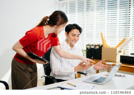 Businesswomen work and discuss their business plans. A Human employee explains and shows her colleague the results paper Businesswomen work and discuss their business plans. A Human employee explains and shows her colleague the results paper 138546469