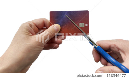 Hands cutting a bank card with scissors, isolated on white background, symbolizing account closure, debt control, financial problems, or canceling payments 138546477