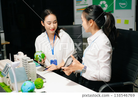 Business professionals presenting sustainable city model with renewable energy, solar panels and wind turbine, green business, ESG, smart city 138546769