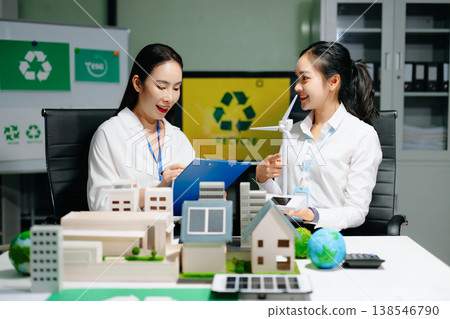 Business professionals presenting sustainable city model with renewable energy, solar panels and wind turbine, green business, ESG, smart city 138546790