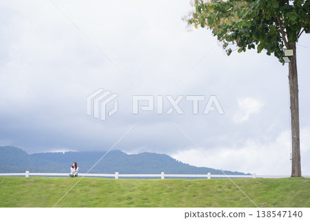 Relax and wellness concept with woman sit on road in garden and mountain background at chiangmai thailand in raining season Relax and wellness concept with woman sit on road in garden and mountain background at chiangmai thailand in raining season 138547140
