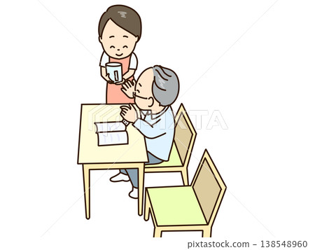 A senior citizen who was reading a book is about to take his medicine. A woman prepares water for him. A senior citizen who was reading a book is about to take his medicine. A woman prepares water for him. 138548960
