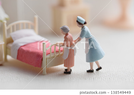 A miniature depiction of everyday caregiving scenes showing gentle support. 138549449