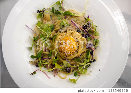 Creamy Spaghetti Carbonara with Raw Egg Yolk and Fresh Herbs Creamy Spaghetti Carbonara with Raw Egg Yolk and Fresh Herbs 138549556