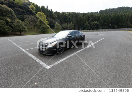 Abandoned car found in park parking lot: No license plates, decaying vehicle, and environmental issues. Abandoned car found in park parking lot: No license plates, decaying vehicle, and environmental issues. 138549806