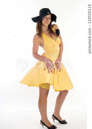 Young woman in summer yellow dress and wide-brim hat posing on white background, summer fashion concept Young woman in summer yellow dress and wide-brim hat posing on white background, summer fashion concept 138550118