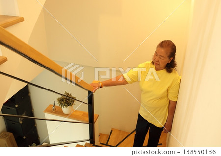 Senior Woman Walking Up Stairs - Top View Senior Woman Walking Up Stairs - Top View 138550136