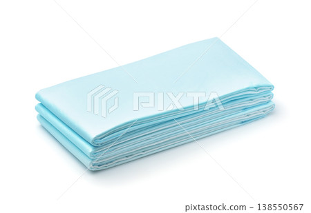 Stack of blue disposable non woven bed sheets 138550567