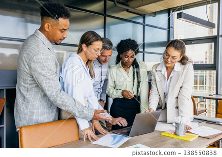 Team of different backgrounds discusses wireframes in shared workspace Team of different backgrounds discusses wireframes in shared workspace 138550838