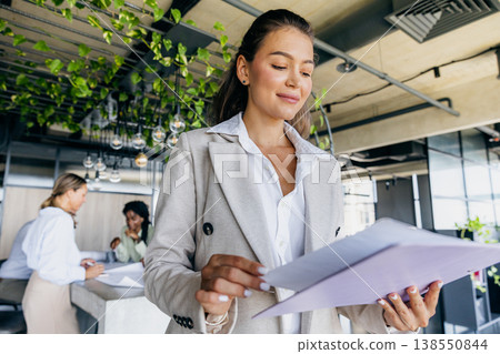 Focused Manager Evaluates Project Plans. Conference Room Filled With Concentrated Project Assessment Focused Manager Evaluates Project Plans. Conference Room Filled With Concentrated Project Assessment 138550844