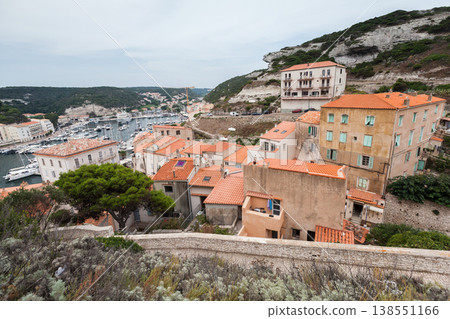 Bonifacio, Corsica. Old residential houses with red tiled roofs nested on the coast Bonifacio, Corsica. Old residential houses with red tiled roofs nested on the coast 138551166