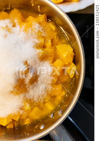 chopped orange pulp topped with white sugar chopped orange pulp topped with white sugar 138551425