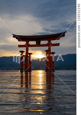 Famous red torii gate of Itsukushima shrine at sunset in Miyajima, Japan 138552140