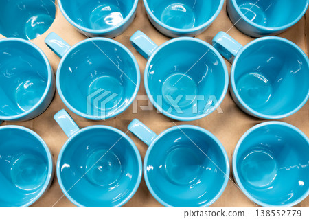 Blue cups and mugs in crockery shop, ceramic dishware, tableware stack in store Blue cups and mugs in crockery shop, ceramic dishware, tableware stack in store 138552779