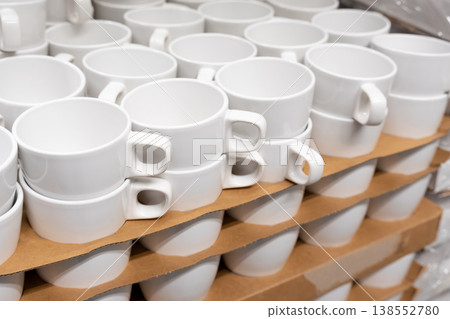 White cups and mugs in crockery shop, ceramic dishware, tableware stack in store White cups and mugs in crockery shop, ceramic dishware, tableware stack in store 138552780