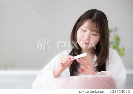 A woman doing self-nail care at home; a beauty lifestyle image of a woman polishing her nails with a nail file. 138553030