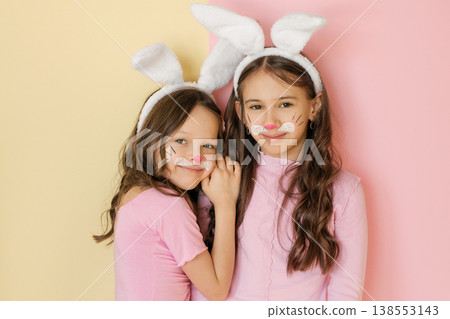 Beautiful smiling girl in rabbit costumes and bunny ears on her head. Painted faces, stage makeup Beautiful smiling girl in rabbit costumes and bunny ears on her head. Painted faces, stage makeup 138553143