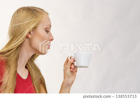 Blonde girl with coffee cup Blonde girl with coffee cup 138553713
