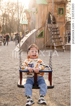 Toddler Enjoying Bucket Swing at Outdoor Playground Toddler Enjoying Bucket Swing at Outdoor Playground 138553893