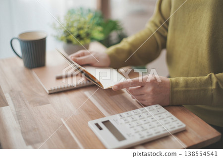 Female hand holding a passbook Female hand holding a passbook 138554541