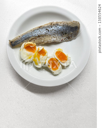 Nutritious and sustainable breakfast showcasing eggs and sardines on bright minimalist setting 138554624